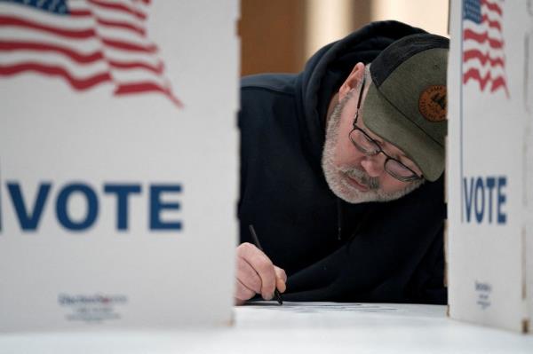 A Wisco<em></em>nsin resident prepares to vote in the presidential primary at the Central Assembly of God church polling place in Douglas County on April 2, 2024.