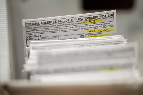 Absentee ballots are prepared before a count at the Wisco<em></em>nsin center for the midterm election on Nov. 8, 2022.