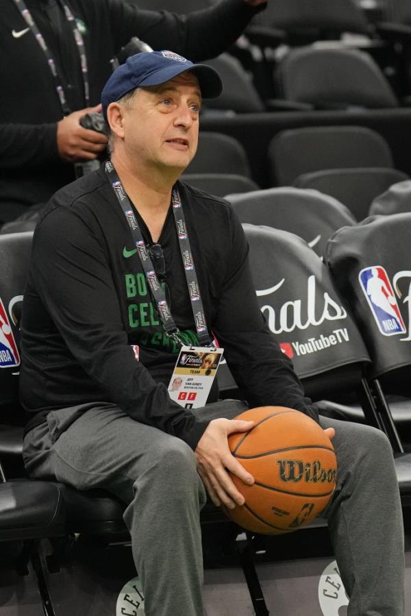 Jeff Van Gundy sitting in TD Garden stadium during the 2024 NBA Finals practice and media availability, holding a basketball