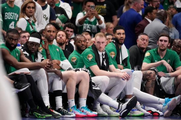 Boston Celtics players, including Jrue Holiday, Jayson Tatum, and Al Horford, reacting to their loss to the Dallas Mavericks during Game 4 of the NBA finals 2024