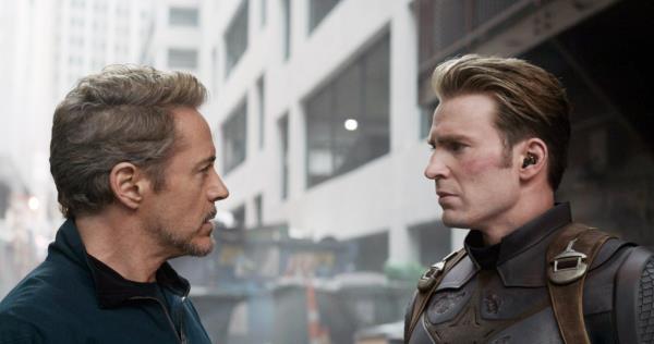 Robert Downey Jr and Chris Evans looking at each other. 