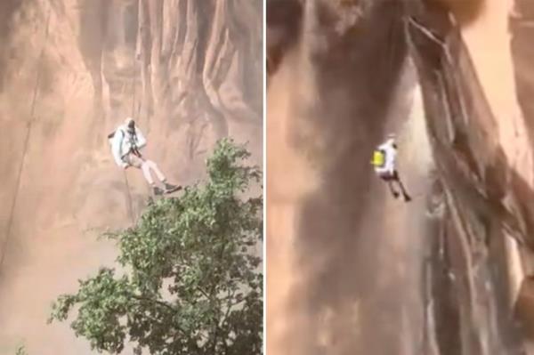 狂风过后，攀登者沿着汹涌的瀑布沿着悬崖下滑:视频