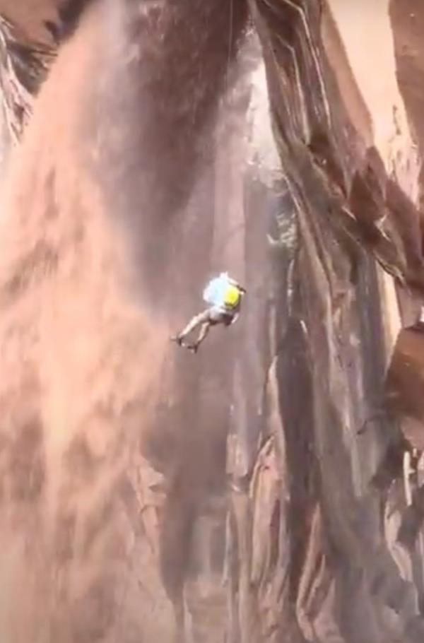 The climber went down the side of the cliff during a massive storm. 