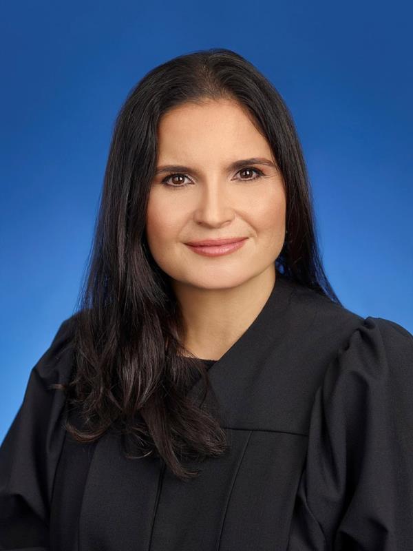 U.S. District Judge Aileen M. Cannon in her black robe, holding a two-page order