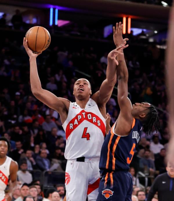 Toro<em></em>nto Raptors forward Scottie Barnes goes up for a shot as New York Knicks guard Immanuel Quickley defends in the second half fat the Madison Square Garden in New York, New York, Monday, January 16, 2023.